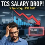A worried Indian IT professional looking at a declining salary graph and a notification showing a pay drop from ₹25,000 to ₹22,800, representing the TCS salary drop news.